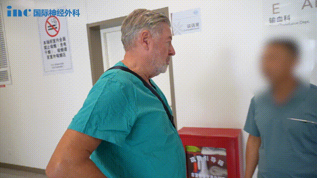 吴先生的父亲一直守候在手术室外，不会说一句英语，只是对着走出手术室的巴教授高高竖起了两个大拇指。